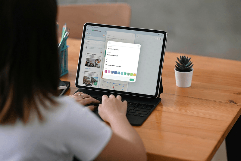 A person typing on an iPad with the Mindspace app showing a "What Went Well Today?" reflection template